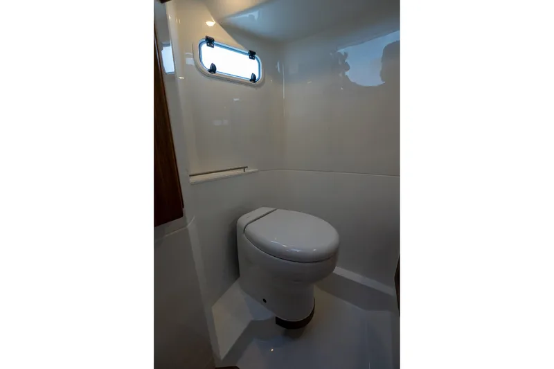 Slide: The Image of Compact bathroom in 2026 Targa 27.2 boat with modern toilet and window. - 60