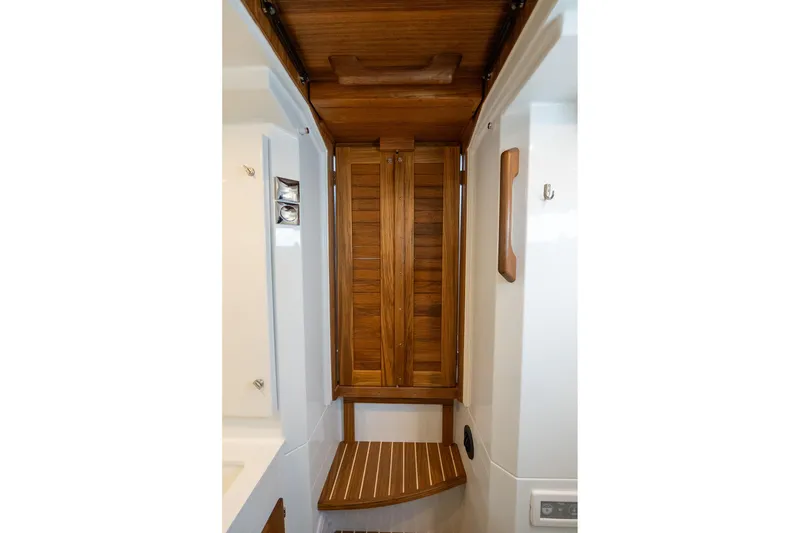 Slide: The Image of Interior of 2026 Targa 27.2 boat featuring wooden cabinetry and seating. - 64