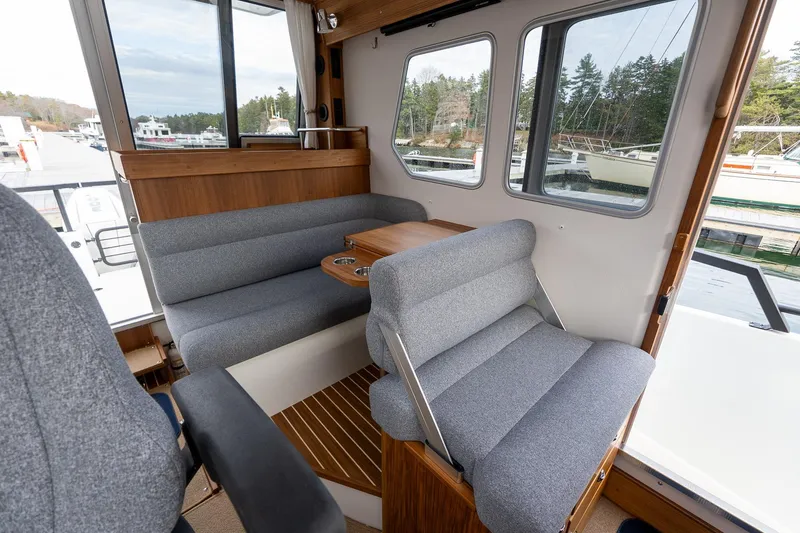 Slide: The Image of Interior of 2026 Targa 27.2 boat with gray seating and wooden accents. - 70