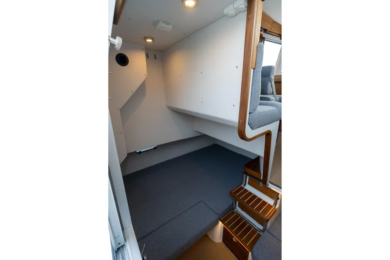 Slide: The Image of Interior of 2026 Targa 27.2 boat with wooden steps and seating area. - 75