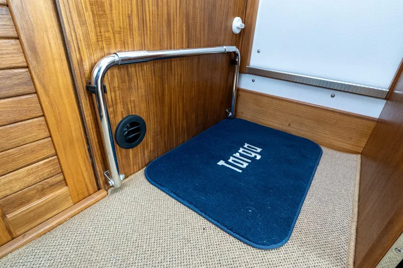 Slide: The Image of Interior of 2026 Targa 27.2 boat with blue branded mat and wooden finish. - 81