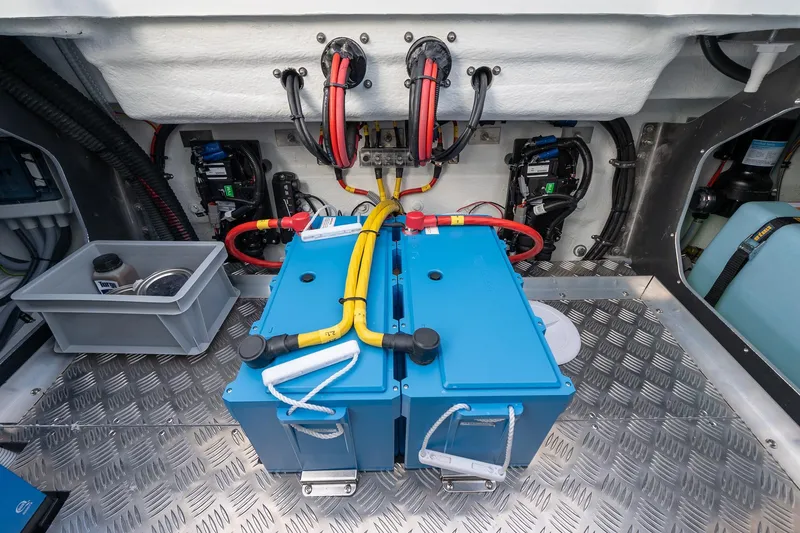 Slide: The Image of Engine compartment of 2026 Targa 27.2 boat with blue battery and wiring. - 89