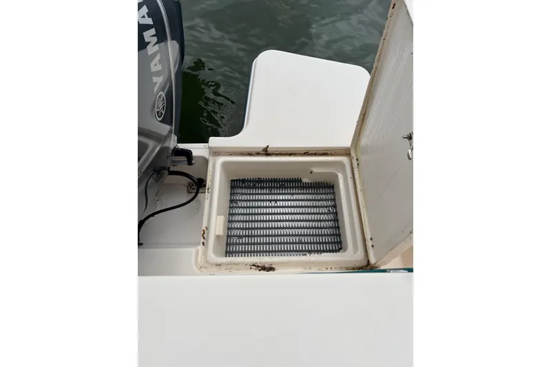 Slide: The Image of Open storage compartment on 2019 Grady-White Freedom 235 boat near water. - 10