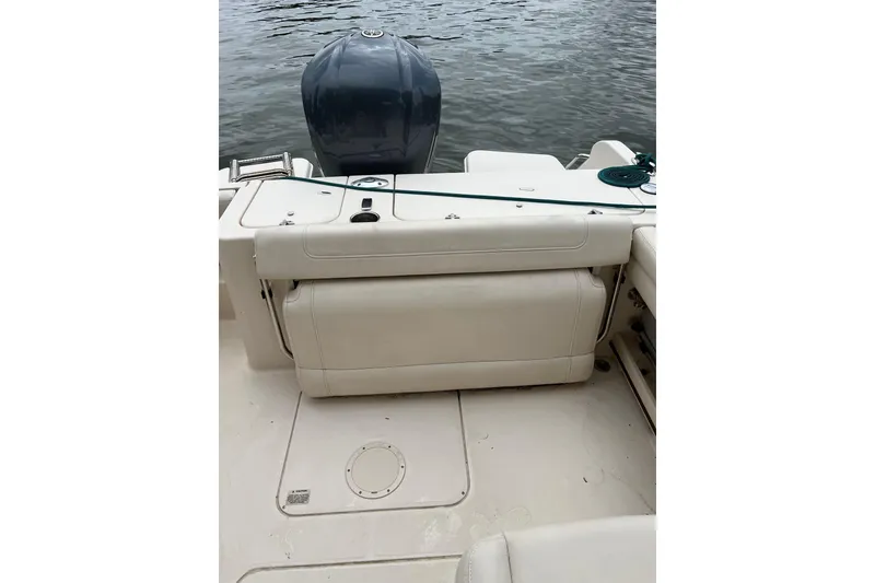 Slide: The Image of 2019 Grady-White Freedom 235 boat interior with engine, on calm water. - 11