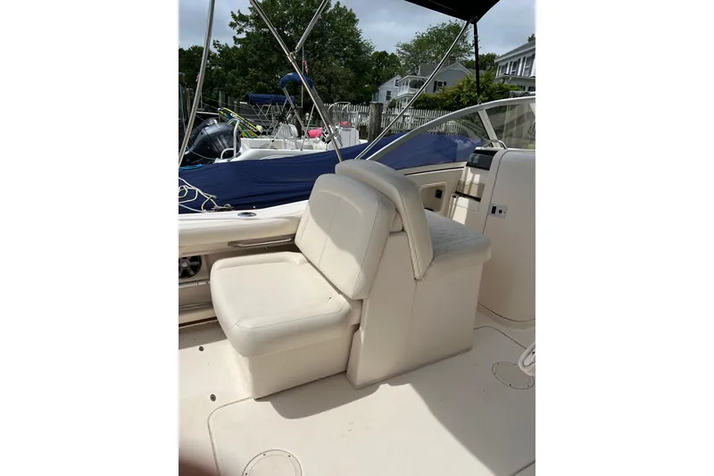 Slide: The Image of 2019 Grady-White Freedom 235 boat interior with cushioned seating and canopy. - 12