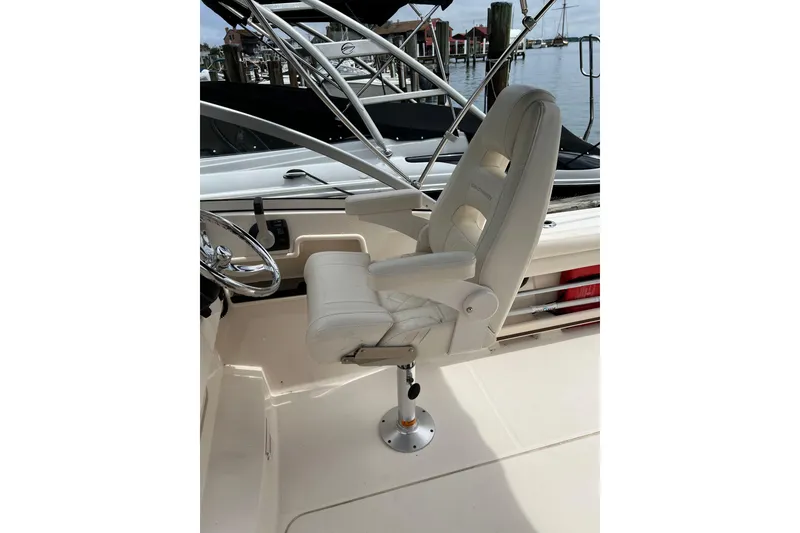 Slide: The Image of Captain's chair on 2019 Grady-White Freedom 235 boat, docked at marina. - 14