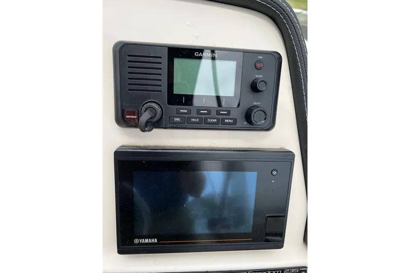 Slide: The Image of Garmin and Yamaha displays on 2019 Grady-White Freedom 235 boat dashboard. - 23
