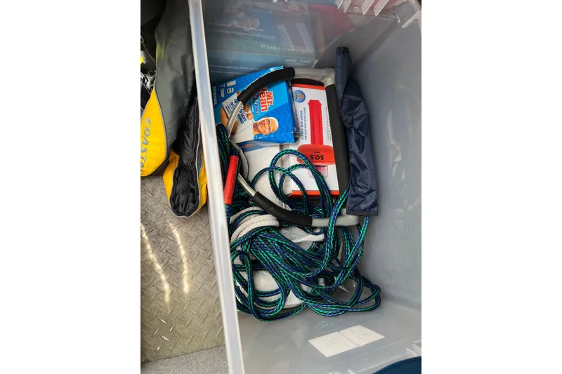 Slide: The Image of Storage compartment in a 2019 Grady-White Freedom 235 boat with safety gear and ropes. - 27