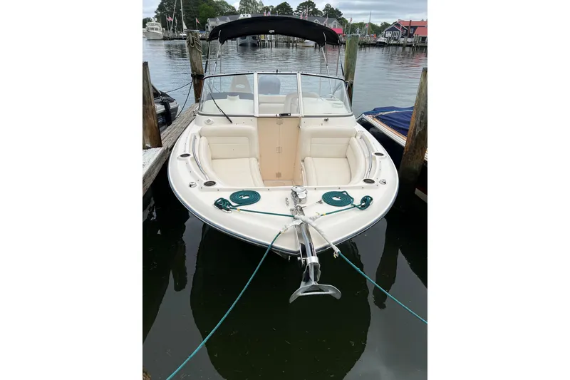 Slide: The Image of 2019 Grady-White Freedom 235 boat docked in a marina, featuring a spacious bow seating area. - 31