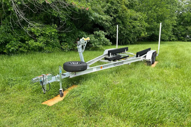 Slide: The Image of Boat trailer for 2019 Grady-White Freedom 235 on grass, surrounded by trees. - 39