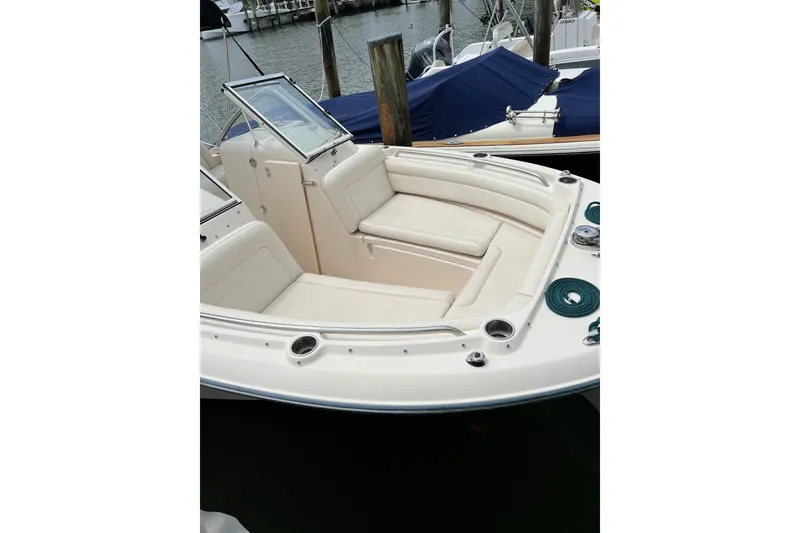 Slide: The Image of 2019 Grady-White Freedom 235 boat with spacious seating, docked at marina. - 4