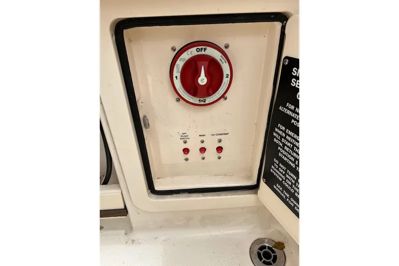 Slide: The Image of Control panel on a 2019 Grady-White Freedom 235 boat, featuring a red dial and switches. - 8