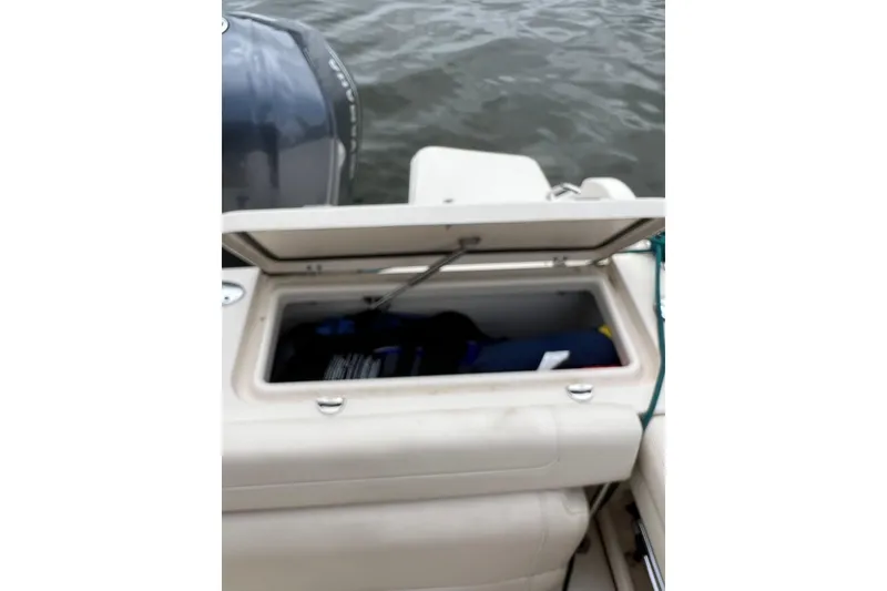 Slide: The Image of Open storage compartment on 2019 Grady-White Freedom 235 boat, near water. - 9