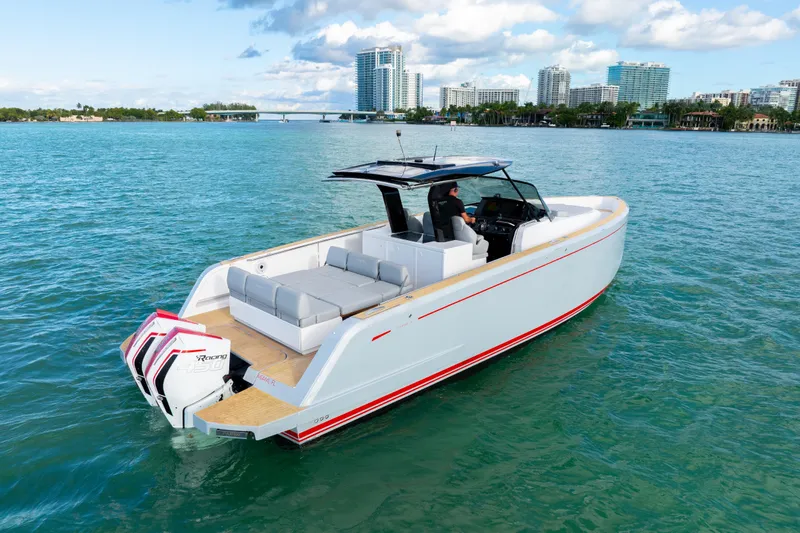 Slide: The Image of Pardo Yachts 38, 2021 model, cruising on clear blue waters near a cityscape. - 16