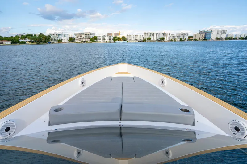 Slide: The Image of Pardo Yachts 38 (2021) bow view with sunbed, overlooking coastal skyline. - 19