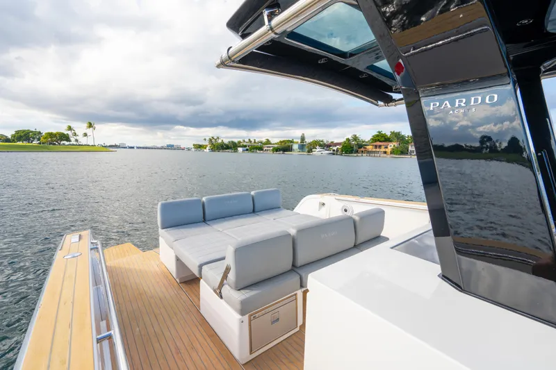 Slide: The Image of 2021 Pardo Yachts 38 luxury deck with seating, overlooking serene waterfront view. - 38