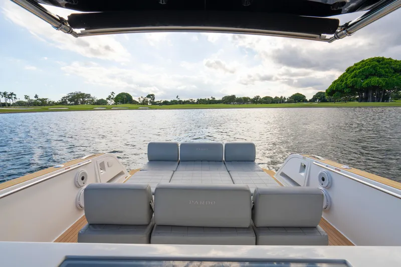 Slide: The Image of 2021 Pardo Yachts 38 with luxurious seating, overlooking serene water and lush greenery. - 42