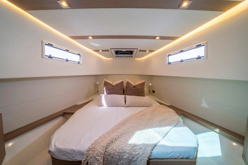 Slide: The Image of Luxurious cabin interior of 2021 Pardo Yachts 38 with cozy bedding and ambient lighting. - 50