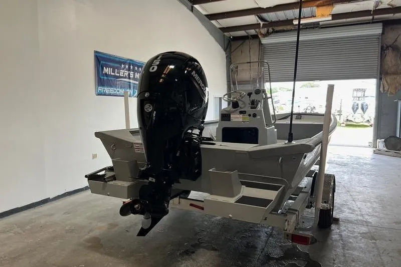 Slide: The Image of 2024 SeaArk 2272 MVT boat with Mercury outboard motor in a garage setting. - 2