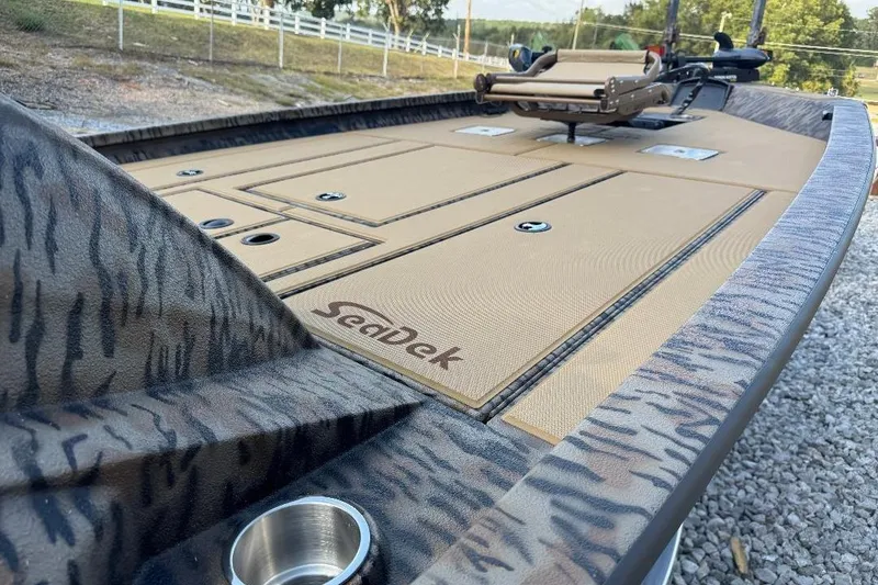 Slide: The Image of 2026 Xpress H20C Crappie boat with SeaDek flooring, camo design, and fishing seat. - 1