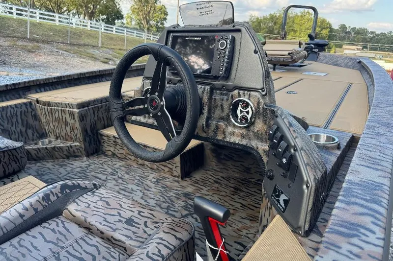 Slide: The Image of 2026 Xpress H20C Crappie boat interior with camo design and advanced dashboard controls. - 3