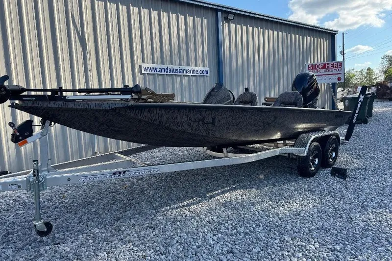 Slide: The Image of 2026 Xpress H20C Crappie boat on trailer, parked on gravel near a metal building. - 9