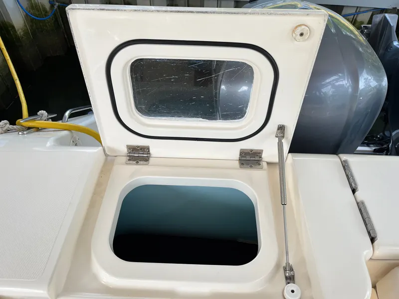 Slide: The Image of Open hatch on 2010 Pursuit OS 345 Offshore boat, showing storage compartment. - 11