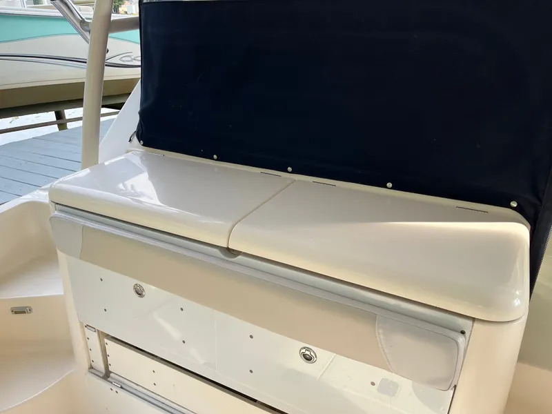 Slide: The Image of 2010 Pursuit OS 345 Offshore boat interior with storage compartment and seating. - 12