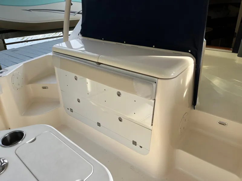 Slide: The Image of 2010 Pursuit OS 345 Offshore boat interior with storage compartment and seating area. - 14