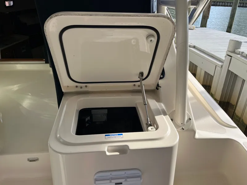 Slide: The Image of Open storage compartment on a 2010 Pursuit OS 345 Offshore boat. - 16
