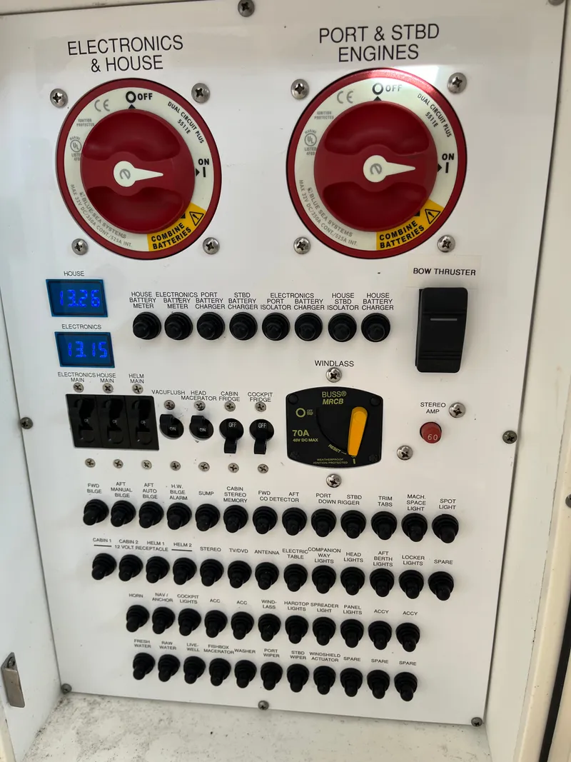 Slide: The Image of Control panel of a 2010 Pursuit OS 345 Offshore boat with switches and gauges. - 18