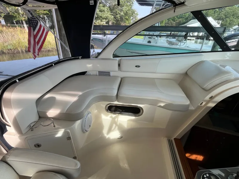 Slide: The Image of 2010 Pursuit OS 345 Offshore boat interior with white seating and American flag. - 19