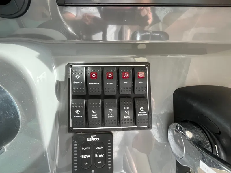 Slide: The Image of Control panel of a 2010 Pursuit OS 345 Offshore boat with labeled switches. - 20