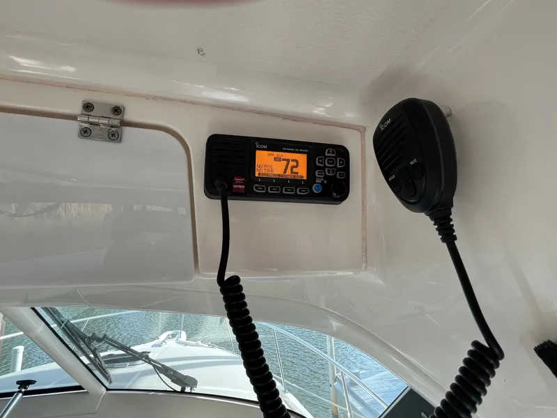 Slide: The Image of VHF radio and microphone inside a 2010 Pursuit OS 345 Offshore boat cabin. - 22