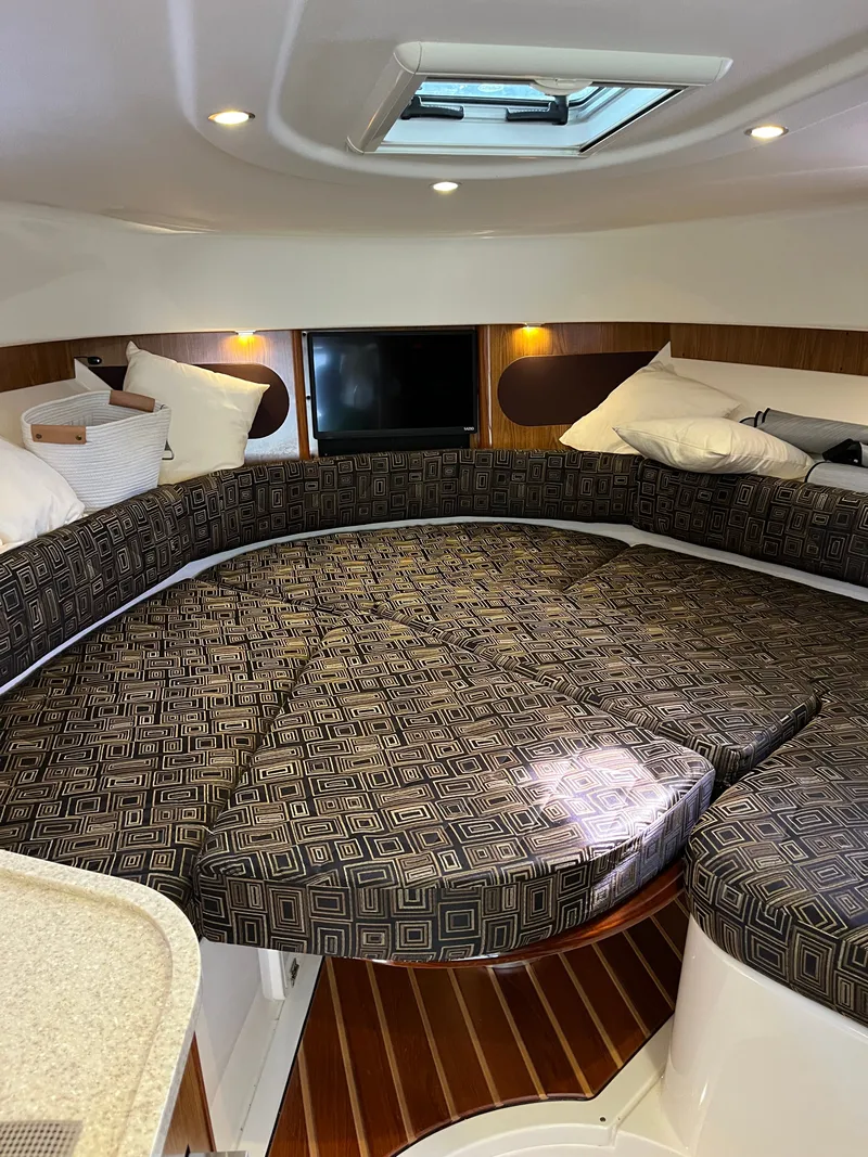 Slide: The Image of 2010 Pursuit OS 345 Offshore cabin interior with patterned seating and skylight. - 35