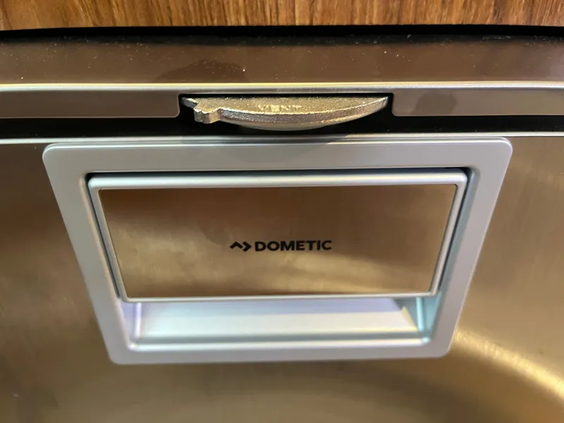 Slide: The Image of Dometic appliance on 2010 Pursuit OS 345 Offshore boat, featuring a sleek metallic design. - 38