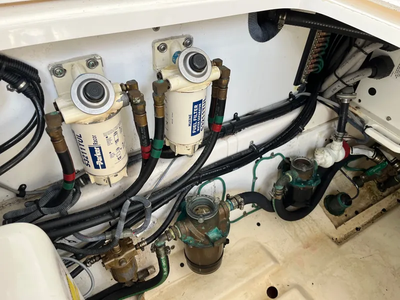 Slide: The Image of Engine compartment of 2010 Pursuit OS 345 Offshore with fuel filters and hoses. - 44