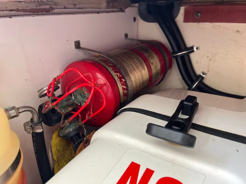 Slide: The Image of Fire extinguisher in 2010 Pursuit OS 345 Offshore boat compartment. - 45