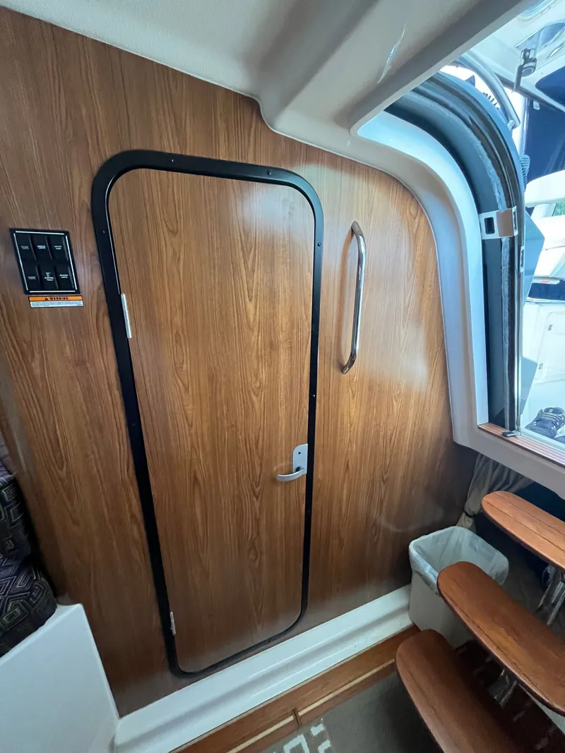 Slide: The Image of Interior of 2010 Pursuit OS 345 Offshore boat with wooden door and steps. - 47