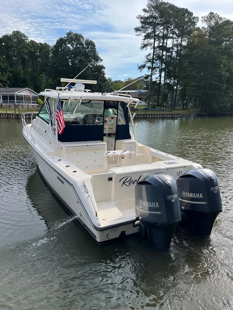 Slide: The Image of 2010 Pursuit OS 345 Offshore boat with twin Yamaha 350 engines on a calm river. - 48