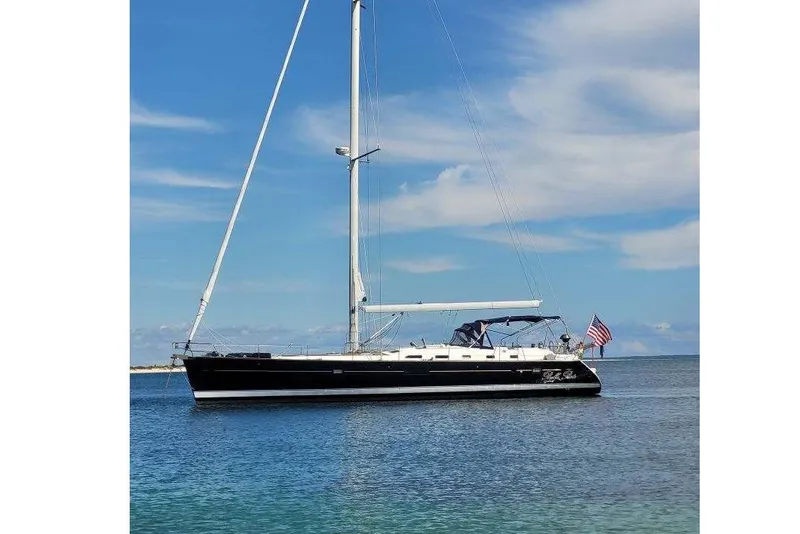 The Image of 2007 Beneteau Oceanis 523 sailboat on calm water under blue sky. - 0