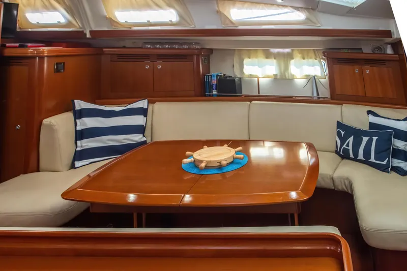 Slide: The Image of Interior of 2007 Beneteau Oceanis 523 yacht with cozy seating and nautical decor. - 11