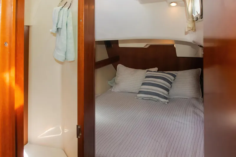 Slide: The Image of Cozy cabin interior of 2007 Beneteau Oceanis 523 sailboat with striped bedding. - 17