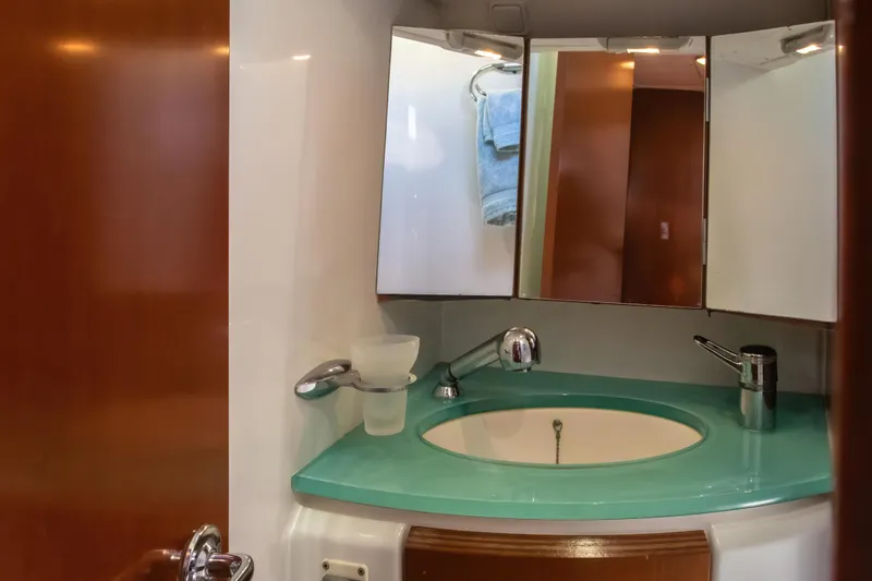 Slide: The Image of Bathroom vanity in 2007 Beneteau Oceanis 523 yacht with turquoise countertop and mirror. - 18