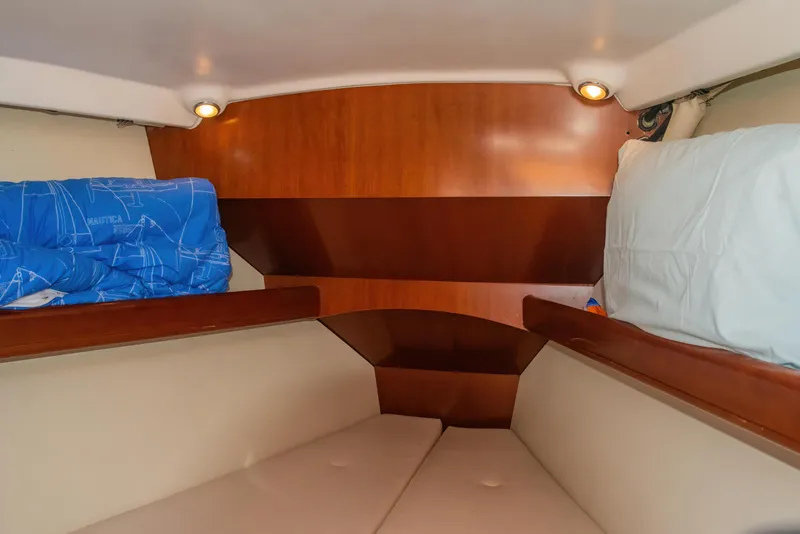 Slide: The Image of Cozy cabin interior of 2007 Beneteau Oceanis 523 sailboat with wooden accents and bedding. - 25