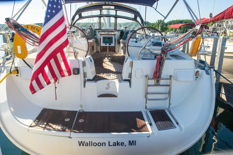 Slide: The Image of Beneteau Oceanis 523 sailboat, 2007 model, docked at Walloon Lake, MI, with American flag. - 30