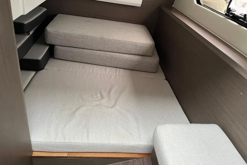 Slide: The Image of Interior cabin of 2025 Jeanneau NC 895 Sport Series 2 with gray cushions. - 17
