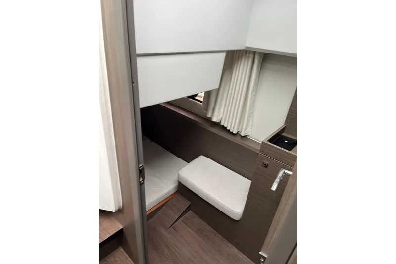 Slide: The Image of 2025 Jeanneau NC 895 Sport Series 2 cabin interior with bed and curtains. - 18