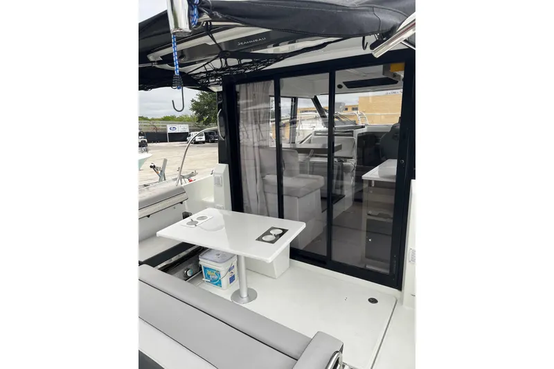 Slide: The Image of 2025 Jeanneau NC 895 Sport Series 2 boat interior with seating and table. - 19