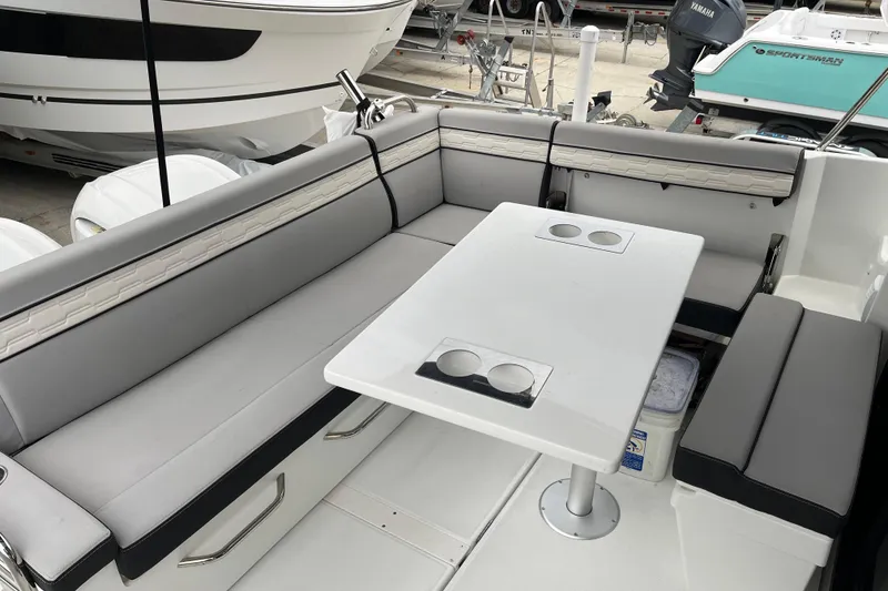 Slide: The Image of 2025 Jeanneau NC 895 Sport Series 2 boat interior with seating and table. - 21